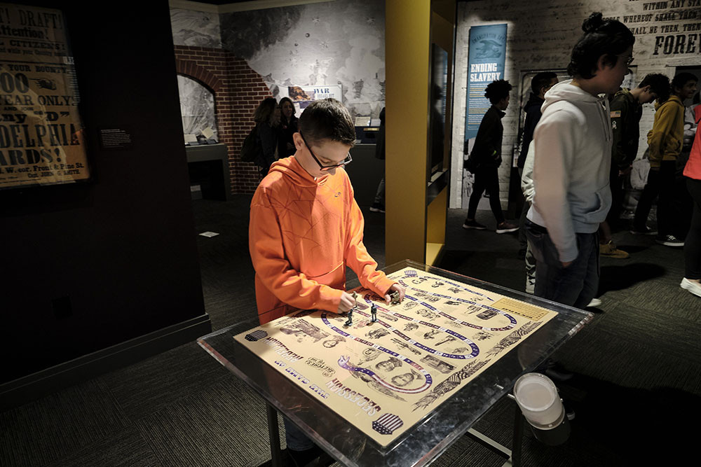 Student examining a Civil War and Reconstruction exhibit document