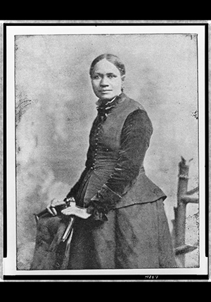 Halftone print of Frances E.W. Harper, three-quarter length portrait, standing, 1898.