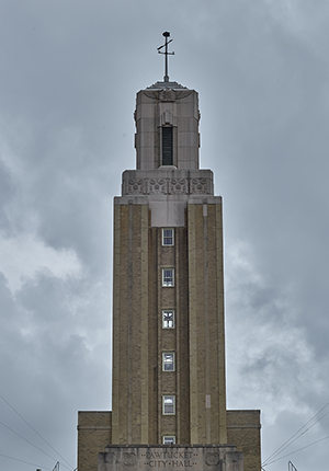 Tower of art deco building with weather vane.